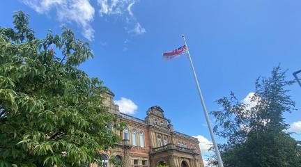 A flag flying from the top of a flagpole on front of Penrith Town Hall