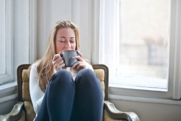 Woman sitting in a chair and drinking tea