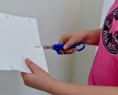 Child using scissors to cut paper