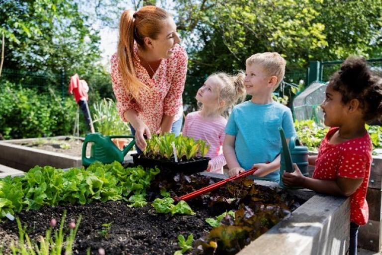 Children and teacher gardening