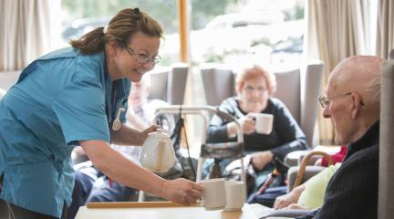 Care worker looking after elderly residents