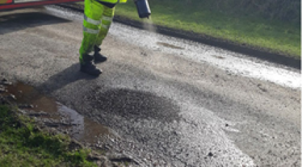 A member of the highways team fixing a pothole using Jet Patching techonology