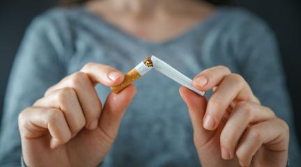 A person snapping a cigarette in half. 