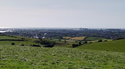 Barrow seen from the Furness hills, with the Irish Sea and wind turbines in the background