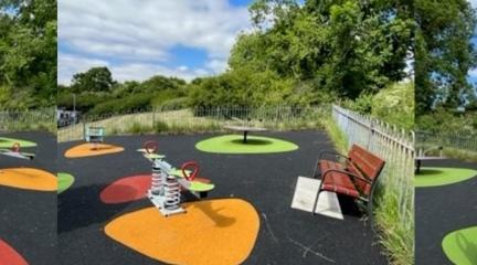 Three pieces of play equipment in vibrant colours - two slides and a seesaw.