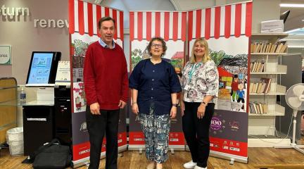 Officers from Westmorland and Furness Council proudly stand alongside Artist Karen MacDougall and the new artwork. (L to R: Charles Thornton, Economic Development Officer at Westmorland and Furness Council; Karen MacDougall, Artist; and Kay Metcalfe, Penrith Library Manager)