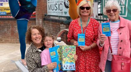 Three women and a young girl holding copies of the new Barrow Treasure Map Trail.