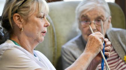 A care worker and an old woman