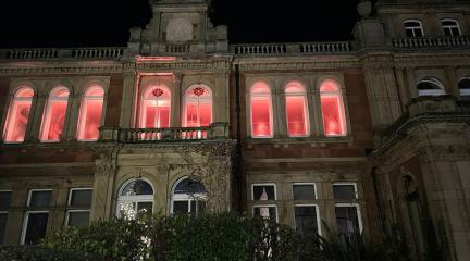 Penrith Town Hall building with windows lit up in orange.