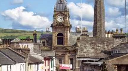 Kendal Town Hall, with blue sky and clouds in the background.