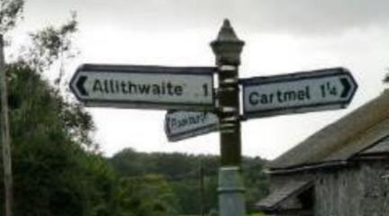 Signpost pointing to Allithwaite and Cartmel.