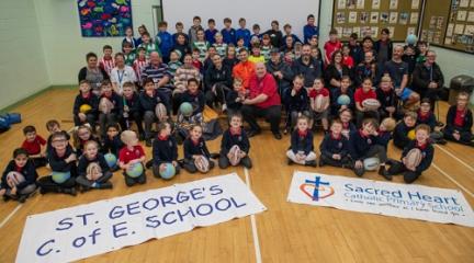 Pupils who have taken part in Step Up and Play with members from the sports clubs and volunteers who transport children to the activities. 