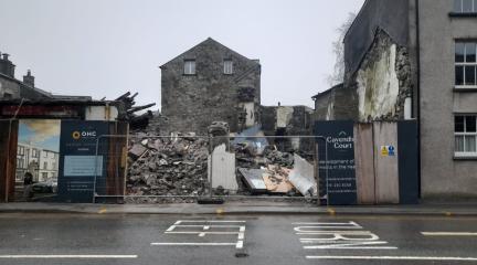 Rubble on a site behind fencing.