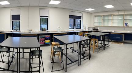 A row of desks in a science classroom.