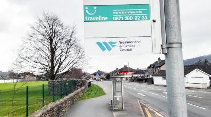 Westmorland and Furness Council bus stop sign on a road