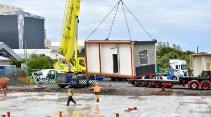 Image of school module being craned into place