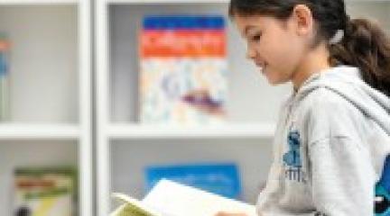 Child sat reading a book