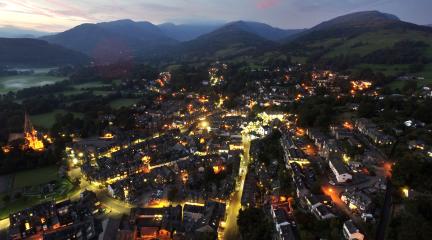 Aerial view of Ambleside at night lit by streetlights 