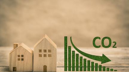 Image to show buildings with a graph and reducing CO2 emissions