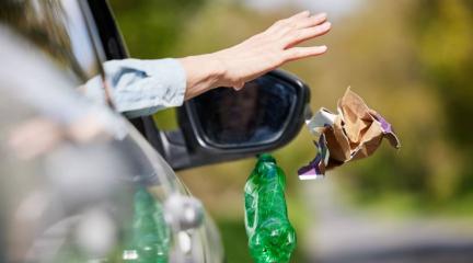 A motorist dropping litter out of a car window