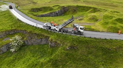 Highways wagon completing surface dressing on a rural road 