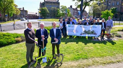 •	'Spade in the ground' marking the start of the Abbey Road cycling and walking scheme construction conducted by Westmorland and Furness Council Cabinet Member, Cllr John Murray (centre), Active Travel England North West Regional Manager, Nick Chamberlain (left) and Steve Cole, Chair of the Brilliant Barrow Board, and CIO and Operational Improvement Director at BAE Systems (right)
