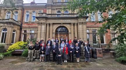 Local dignitaries, veterans, cadets and members of the RBL at the Armed Forces Day flag raising ceremony outside the town hall building in Penrith