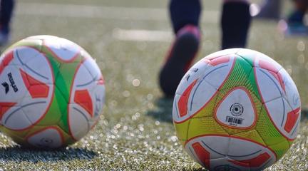 Footballs on a training pitch