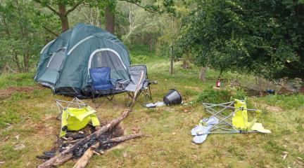 Fly camping, a camping fire using trees from the local area and rubbish left at a National Trust green space