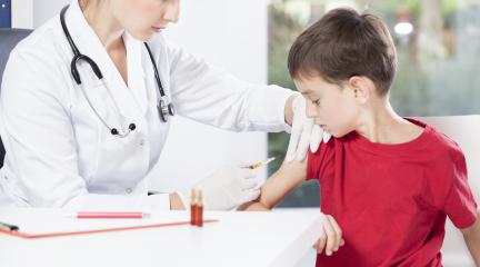 doctor helping child have immunisation