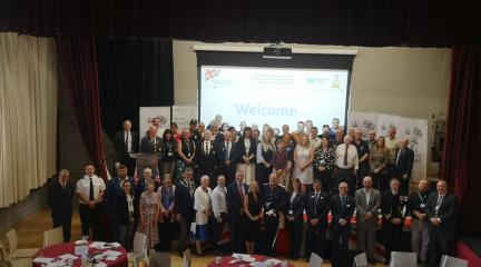 Attendees stood on stage at Armed Forces Community Collaboration Event