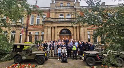 VJ Day flag raising event outside the town hall building in Penrith