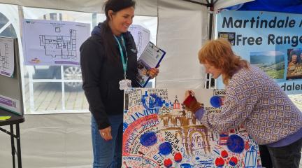 Penrith Town Hall Market Stall where an artist is talking to turning people.