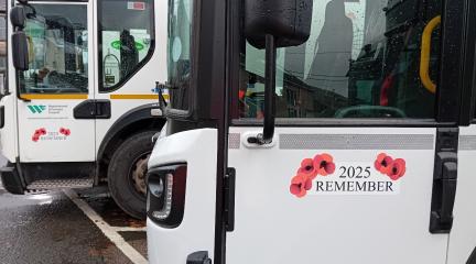 Poppy sticker with text reading '2025 REMEMBER' on council vehicles.