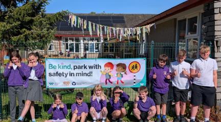 School children with a road safety banner