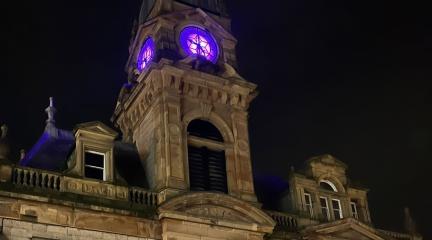 Kendal Town Hall clock face illuminated purple