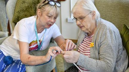 A council worker supporting an older lady