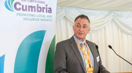 Councillor Jonathan Brook standing at a lecturn giving a speech.