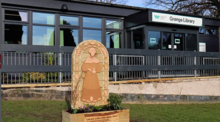 A carved wooden planter in the grounds of Grange Library.