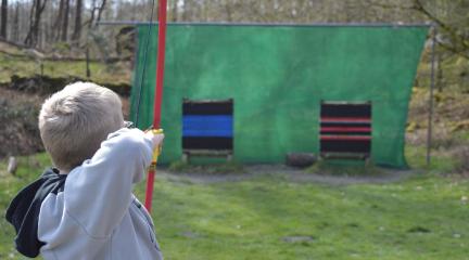 Child learning archery at holiday club