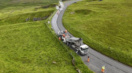Surface dressing work being carried out on a road in Westmorland and Furness