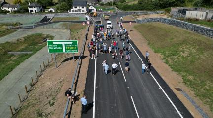 A drone view of people walking along the new road.