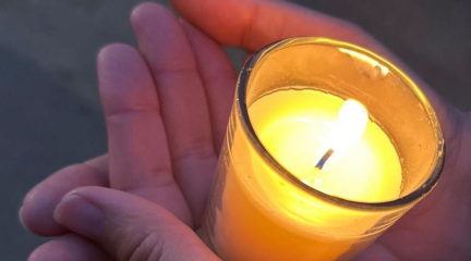 Hands holding a candle