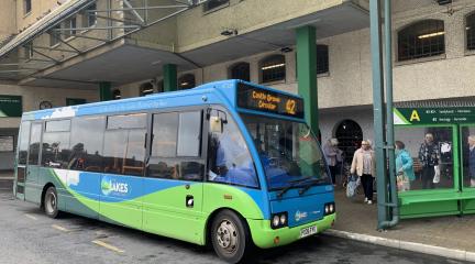 A bus waiting at a bus stop at Kendal bus station.