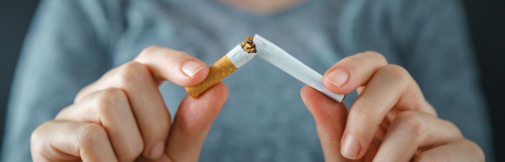 A person snapping a cigarette in half.
