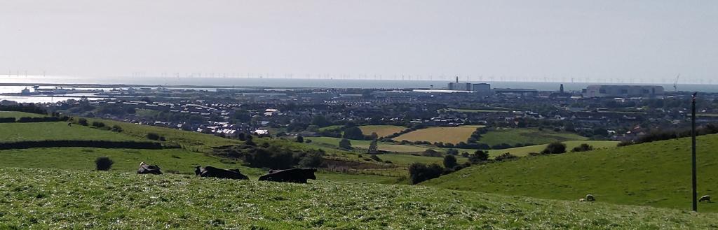 Barrow seen from the Furness hills, with the Irish Sea and wind turbines in the background