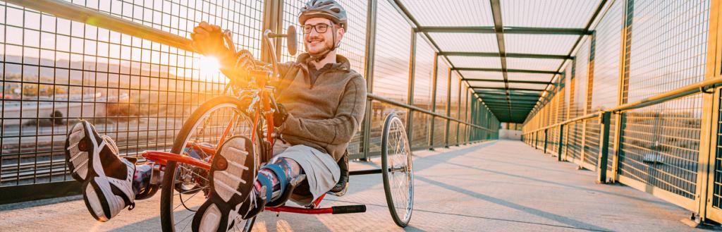 Man crosses bridge riding adapted bike