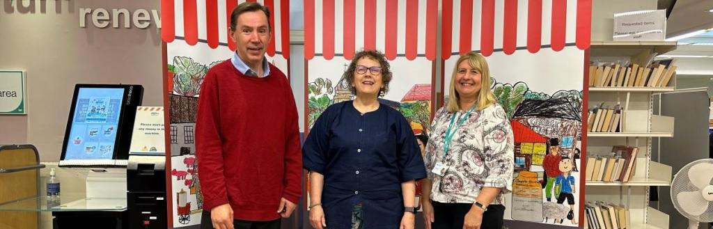 Officers from Westmorland and Furness Council proudly stand alongside Artist Karen MacDougall and the new artwork. (L to R: Charles Thornton, Economic Development Officer at Westmorland and Furness Council; Karen MacDougall, Artist; and Kay Metcalfe, Penrith Library Manager)