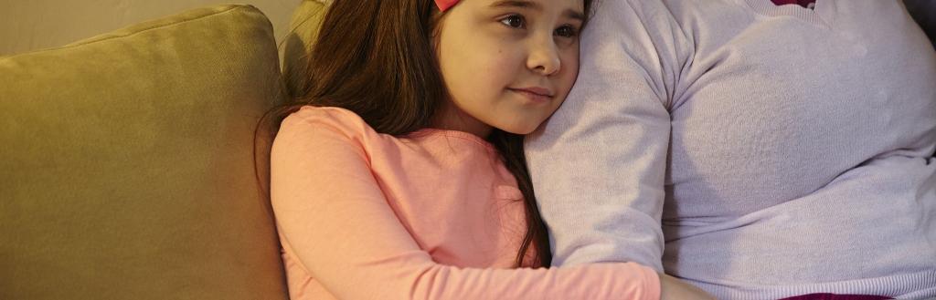 A child hugs her kinship carer