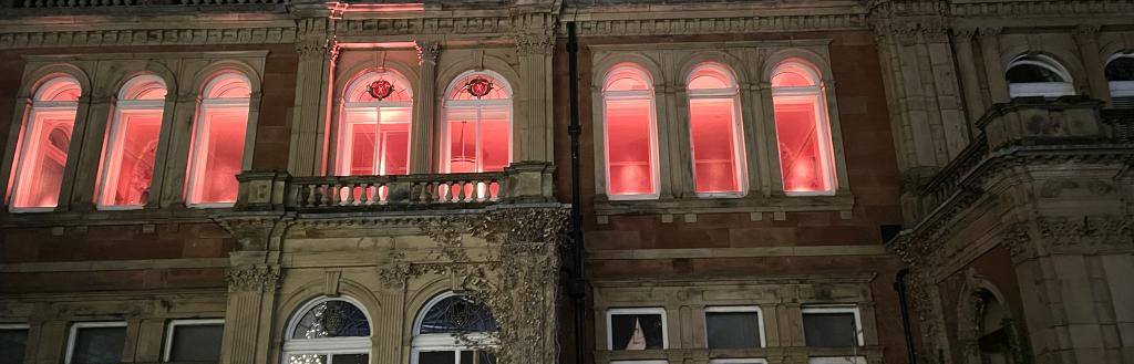 Penrith Town Hall building with windows lit up in orange.